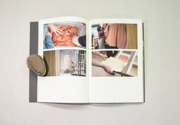 An open book displaying photographs of Clodagh Emoe's studio practice